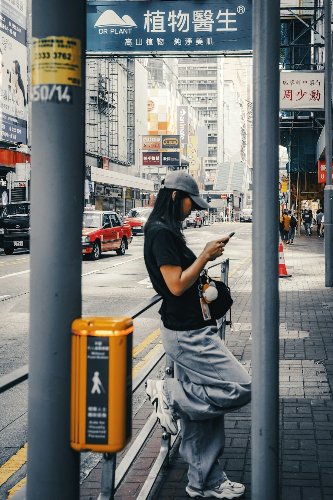 Someone checking their phone on a Hong Kong street